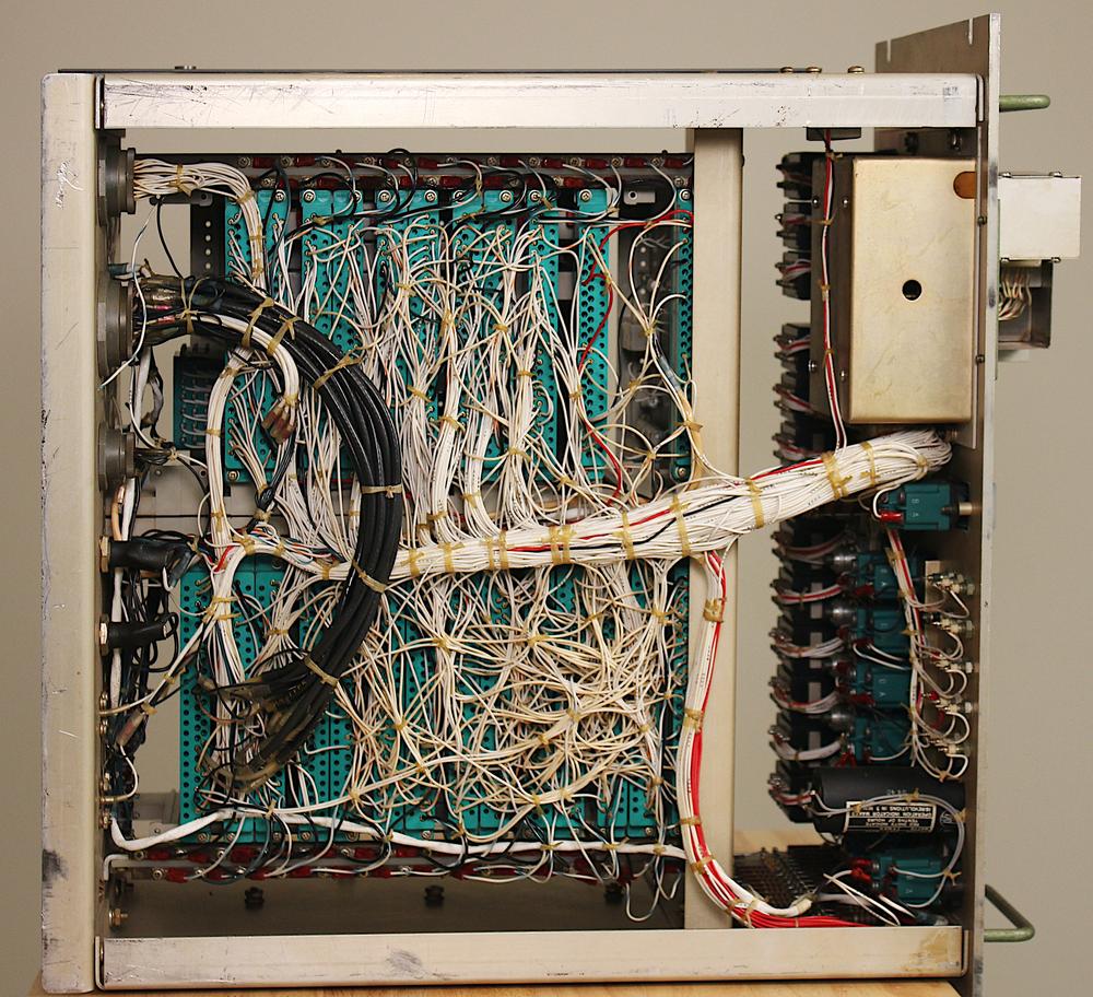 The backplane wiring of the Test Set consisted of bundles of white wires, as shown in this view of the underside of the Test Set.
