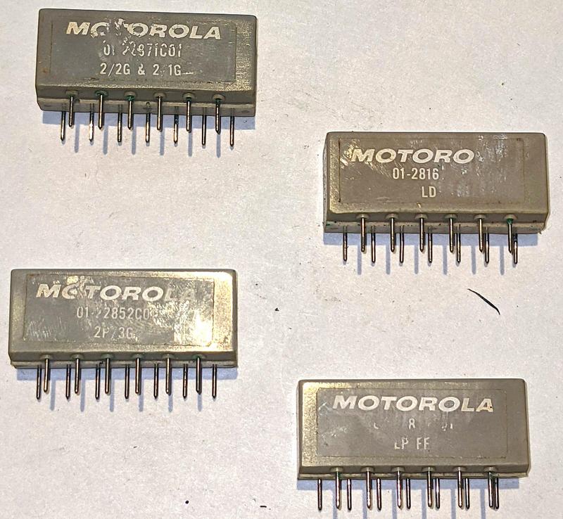 Four of the 13-pin Motorola modules. These implement logic gates (2/2G & 2/1G), lamp drivers (LD), more logic gates (2P/3G), and a flip-flop (LP FF). The modules have 13 staggered pins, ensuring that they can't be plugged in backward.